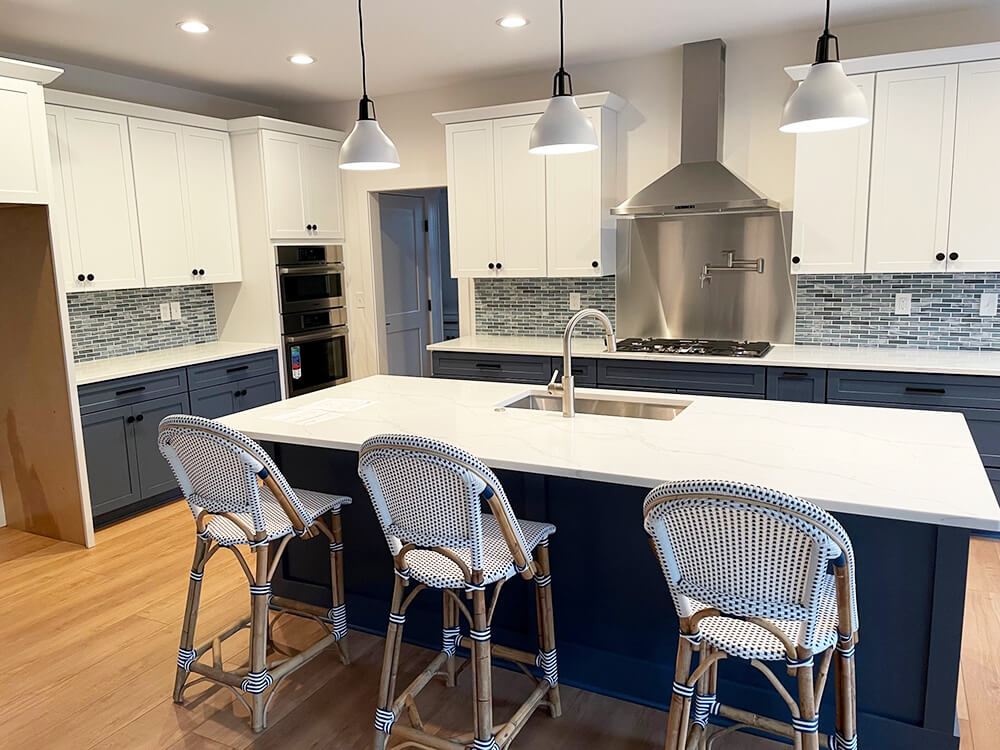 Blue and white kitchen designed, cabinets, countertop, kitchen flooring and lighting. Kitchen design and kitchen installation by Lumberjack's Kitchens and Baths, serving NE Ohio